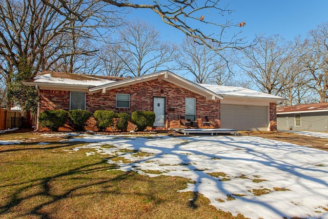 view of front of property with a garage and a lawn