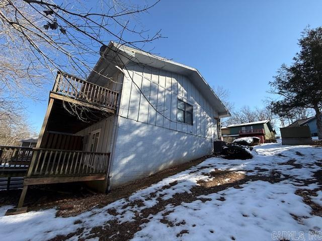 snow covered property featuring a balcony