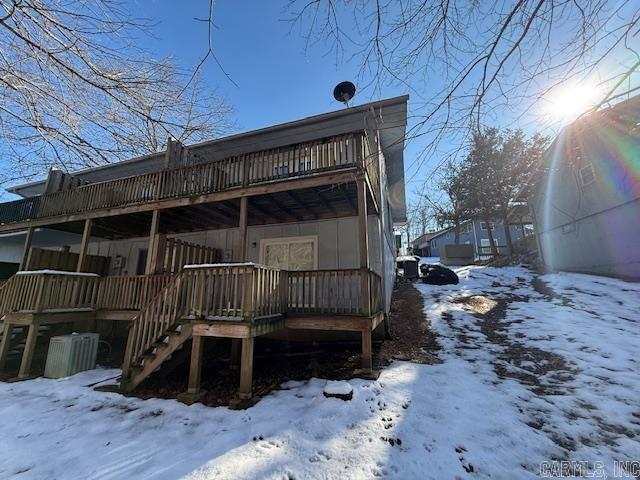 snow covered property with a deck