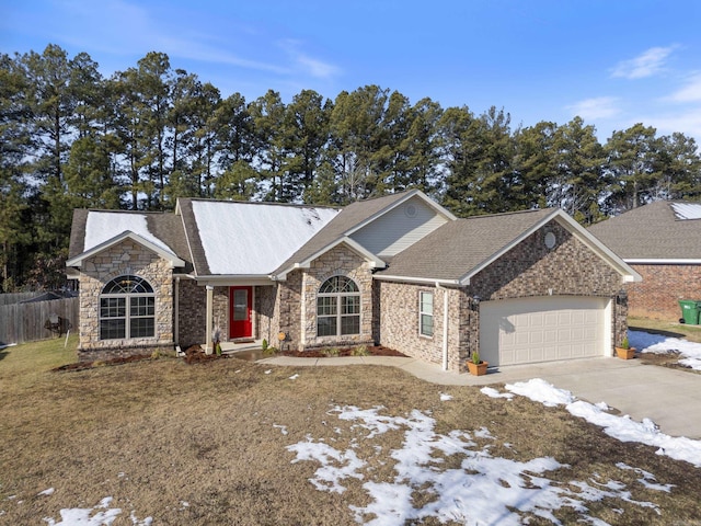 ranch-style home with a yard and a garage