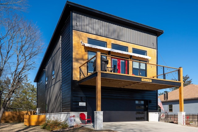 contemporary house featuring a balcony and a garage