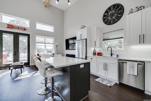 kitchen featuring sink, white cabinets, a center island, and appliances with stainless steel finishes