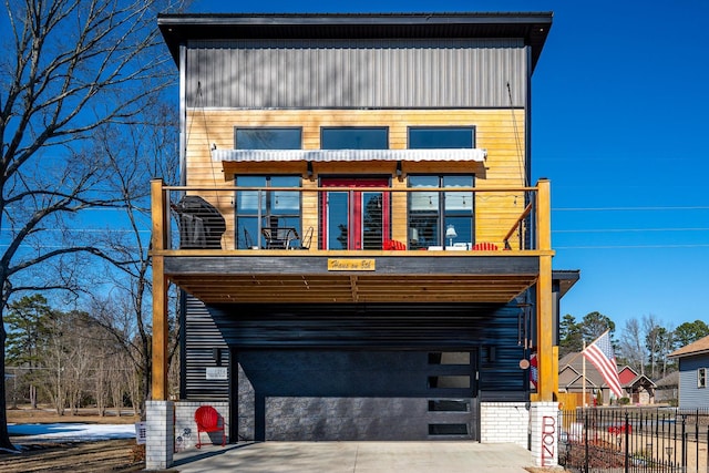 contemporary home featuring a balcony and a garage