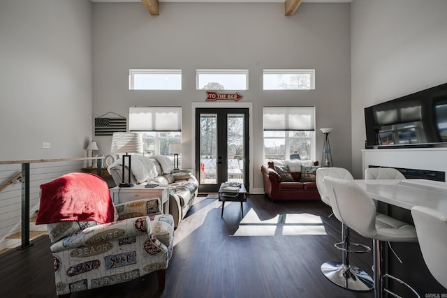 living room with a high ceiling, dark hardwood / wood-style flooring, french doors, and beamed ceiling