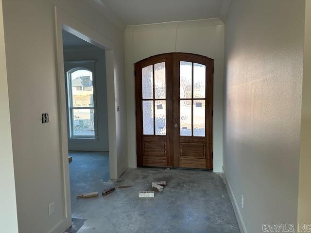 doorway featuring ornamental molding and french doors