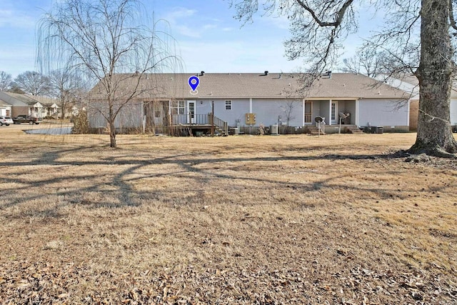 rear view of house with a yard