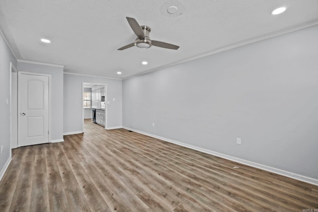 unfurnished living room featuring a textured ceiling, ceiling fan, ornamental molding, and dark hardwood / wood-style flooring