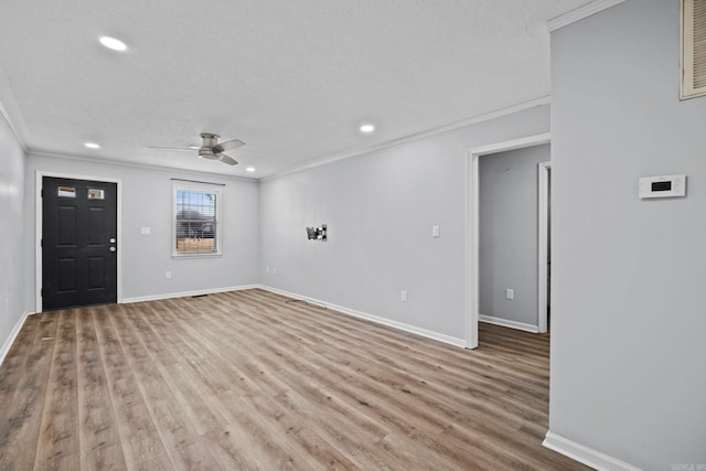 interior space featuring ornamental molding, ceiling fan, light hardwood / wood-style flooring, and a textured ceiling