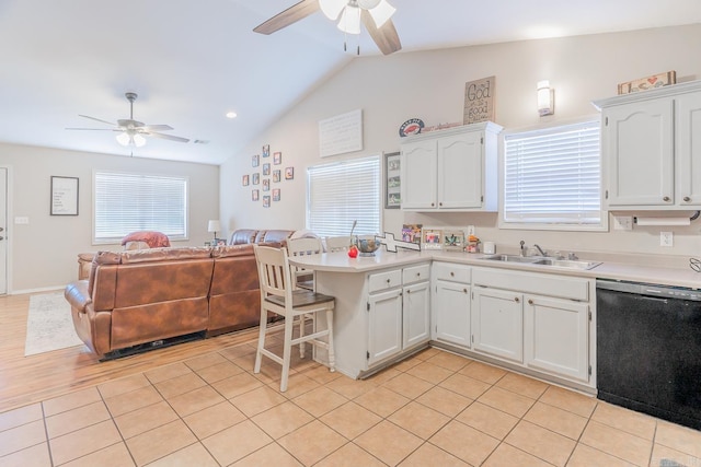 kitchen featuring sink, dishwasher, light tile patterned floors, and white cabinetry