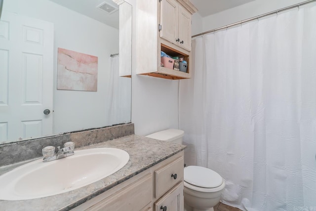 bathroom with toilet and vanity