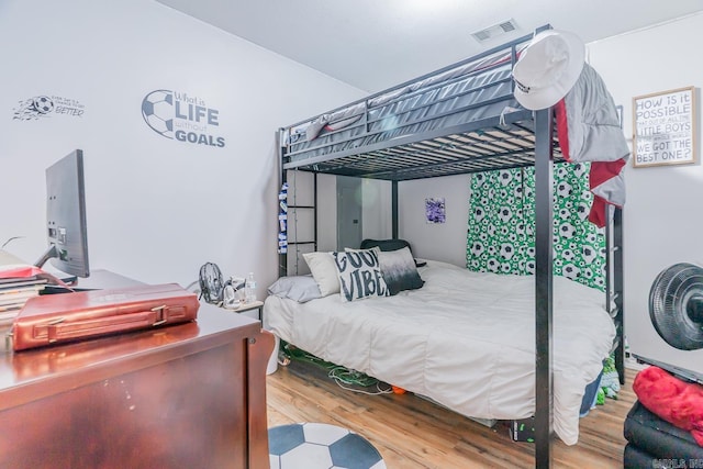 bedroom with hardwood / wood-style flooring