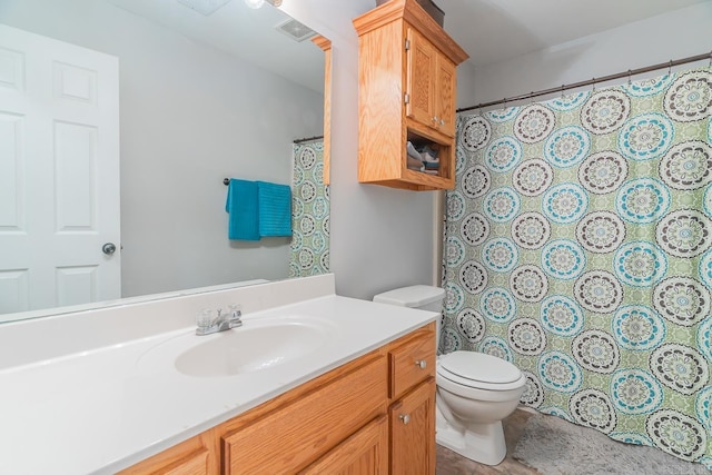 bathroom featuring toilet and vanity