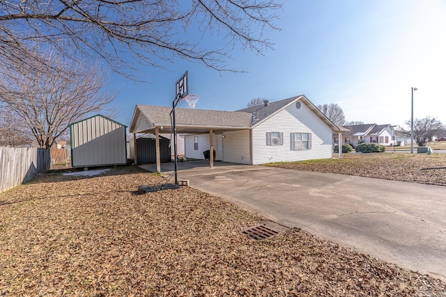 single story home with a carport and a storage shed