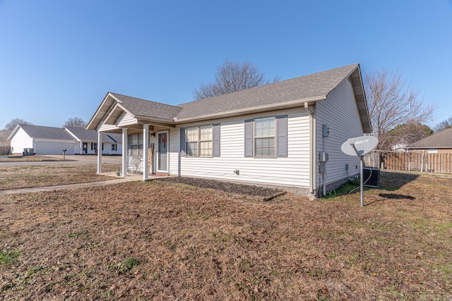 view of front of house featuring cooling unit and a front yard