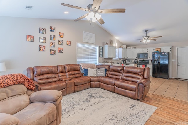 living room with vaulted ceiling, ceiling fan, and light hardwood / wood-style floors