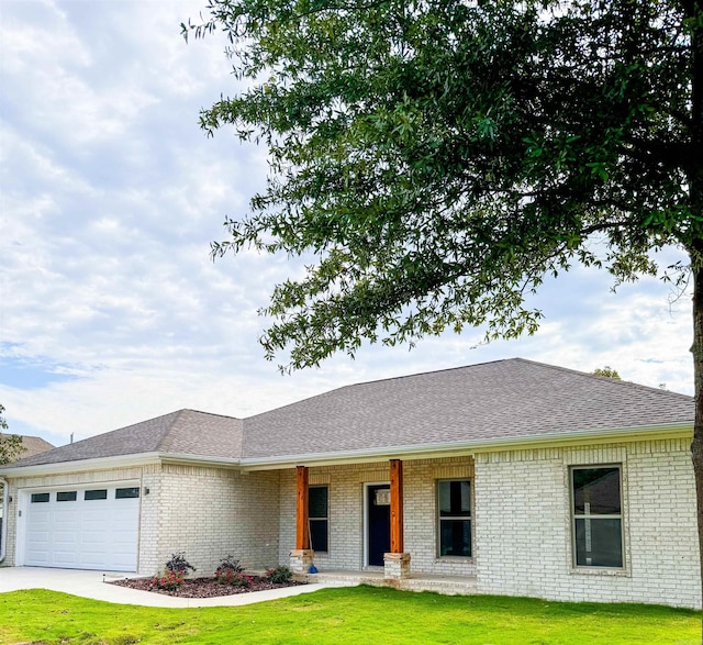 single story home featuring a garage and a front lawn