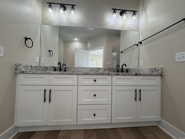 bathroom with hardwood / wood-style floors and vanity