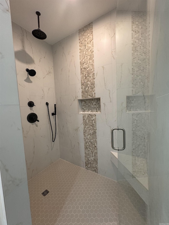 bathroom featuring a shower with shower door