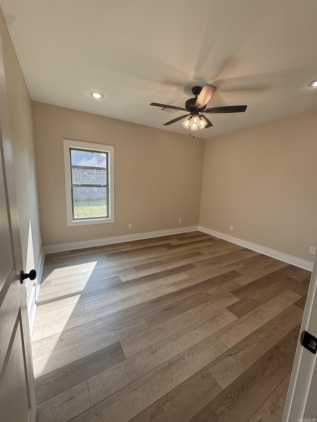 empty room featuring ceiling fan and wood-type flooring