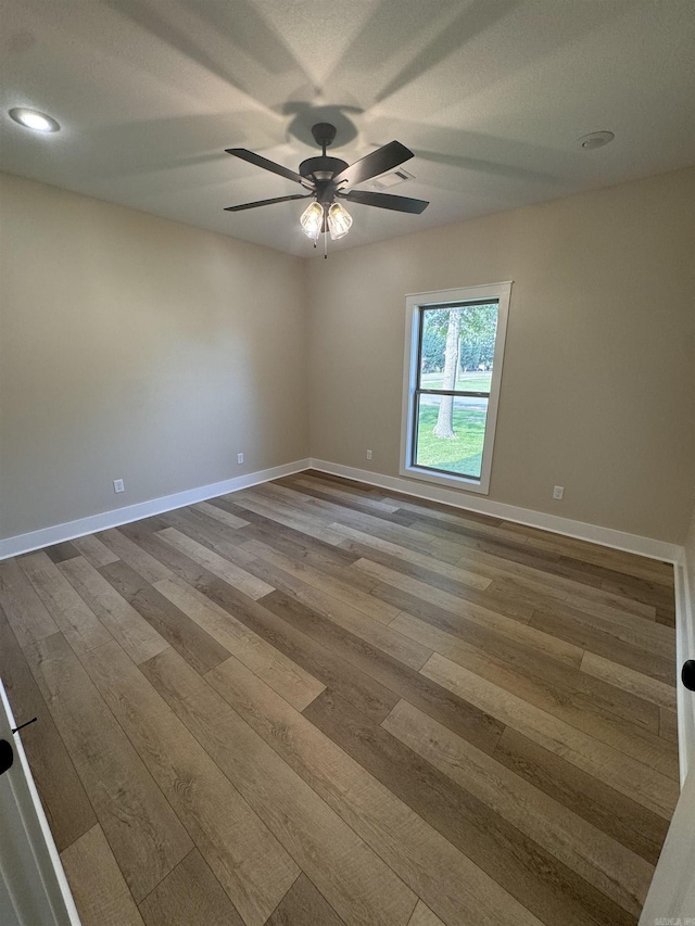 spare room featuring hardwood / wood-style flooring and ceiling fan