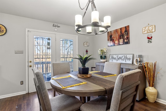 dining space with a notable chandelier and dark hardwood / wood-style floors