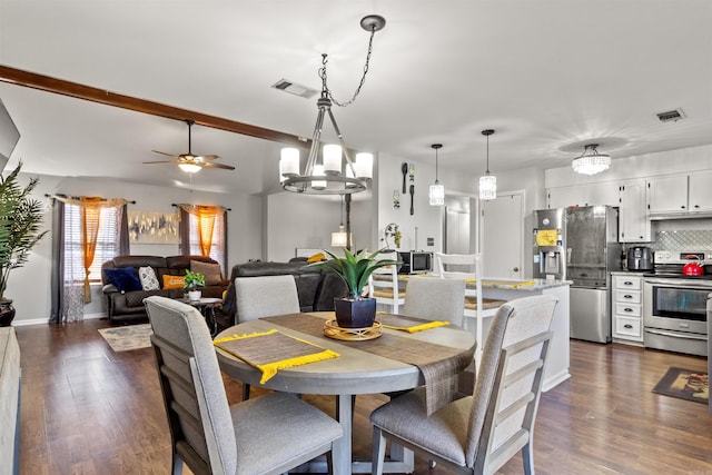 dining space featuring dark wood-type flooring, lofted ceiling with beams, and ceiling fan with notable chandelier