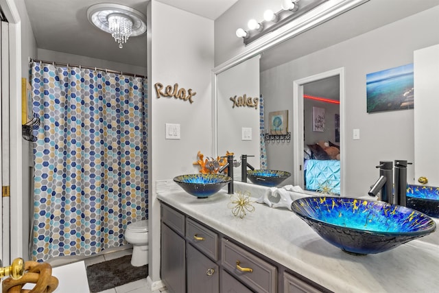 bathroom featuring an inviting chandelier, toilet, walk in shower, tile patterned floors, and vanity