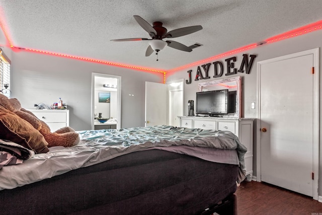 bedroom with a textured ceiling, ceiling fan, and dark wood-type flooring