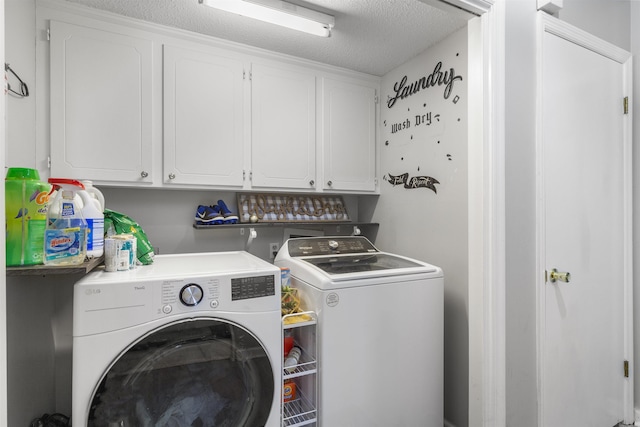 clothes washing area with a textured ceiling, washing machine and dryer, and cabinets