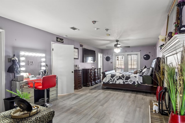 bedroom with ceiling fan and light wood-type flooring