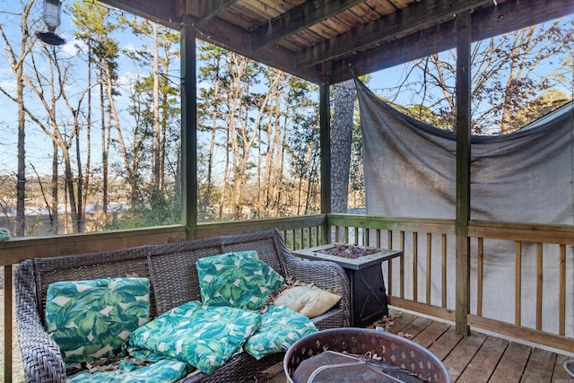 wooden deck featuring an outdoor fire pit