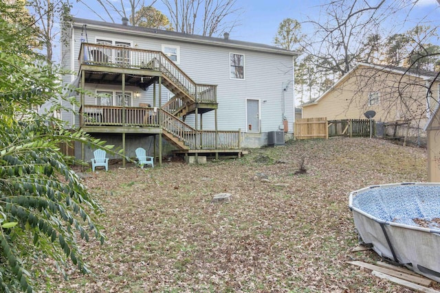 rear view of property with cooling unit and a pool side deck