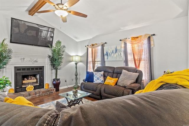 living room featuring a fireplace, ceiling fan, lofted ceiling with beams, and hardwood / wood-style floors