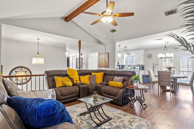 living room with vaulted ceiling with beams, ceiling fan with notable chandelier, and hardwood / wood-style flooring