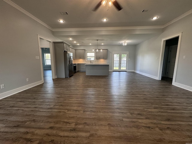 unfurnished living room with ornamental molding, ceiling fan, french doors, dark hardwood / wood-style floors, and sink