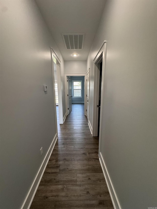 corridor with dark hardwood / wood-style floors