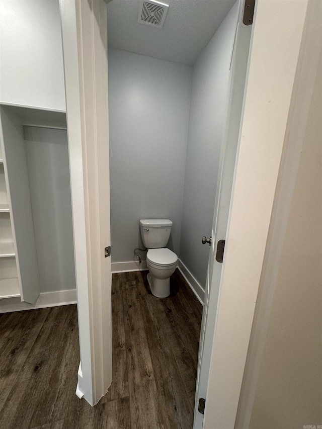 bathroom with hardwood / wood-style floors and toilet