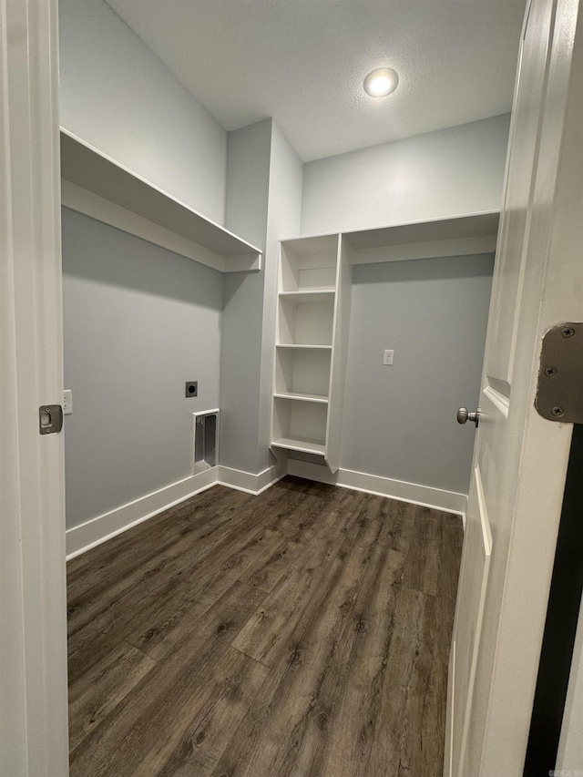 laundry area featuring dark hardwood / wood-style flooring, electric dryer hookup, and a textured ceiling