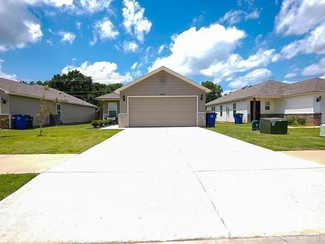 ranch-style house featuring central AC unit, a front lawn, and a garage