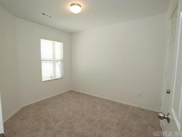 spare room with light colored carpet