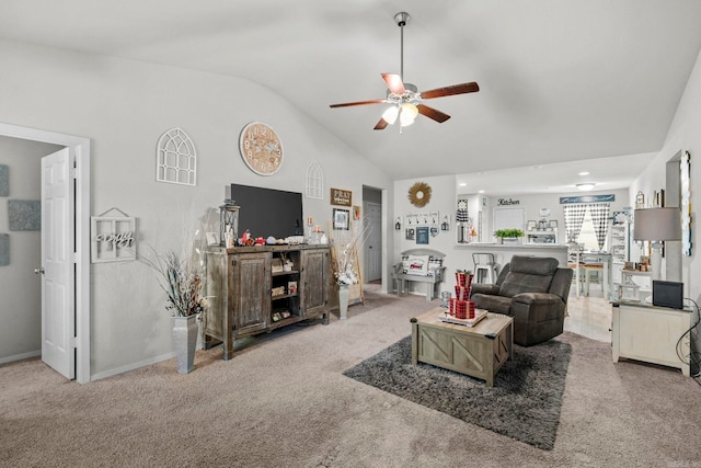 carpeted living room with ceiling fan and lofted ceiling