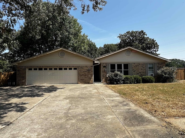 ranch-style house with a front yard and a garage