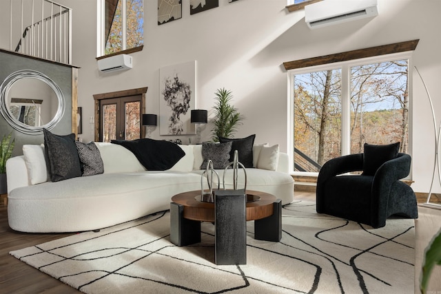 living room with a wall mounted AC and hardwood / wood-style flooring