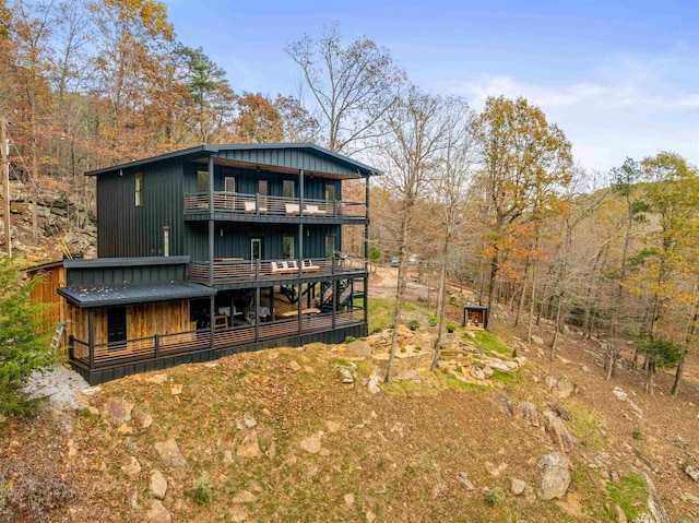 back of property featuring a balcony