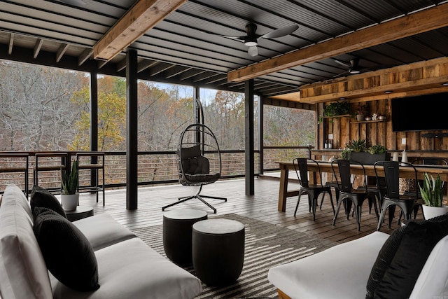 sunroom / solarium featuring ceiling fan