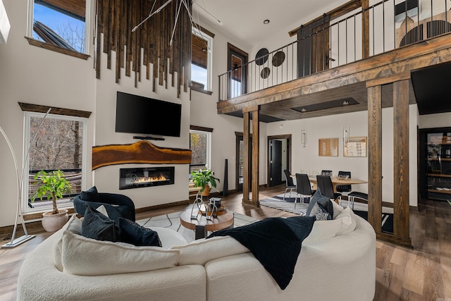 living room with a high ceiling and hardwood / wood-style flooring