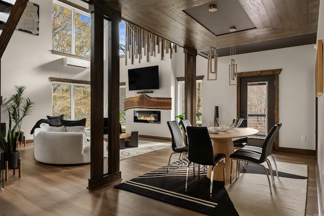 dining room with wood ceiling and light hardwood / wood-style flooring