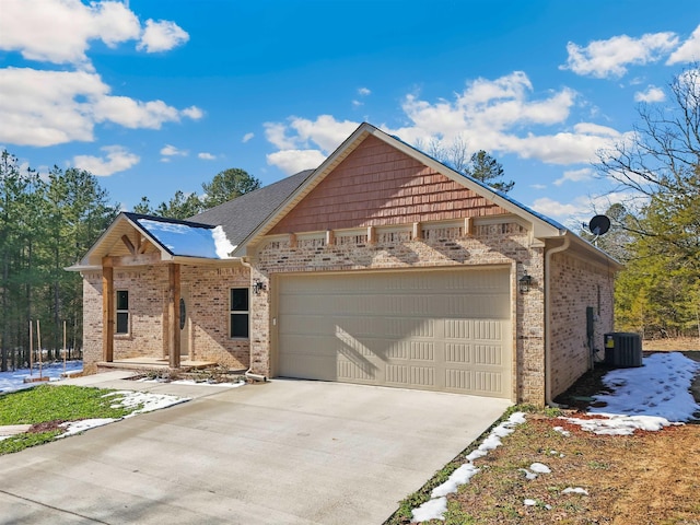 view of front facade with a garage and cooling unit