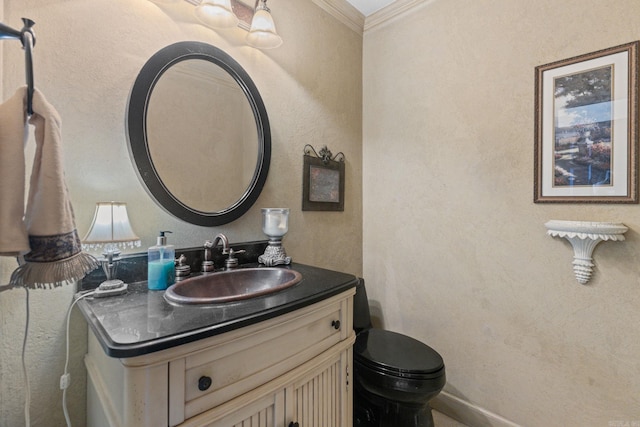 bathroom featuring toilet, crown molding, and vanity