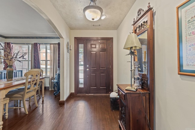 entrance foyer featuring a textured ceiling and dark hardwood / wood-style flooring